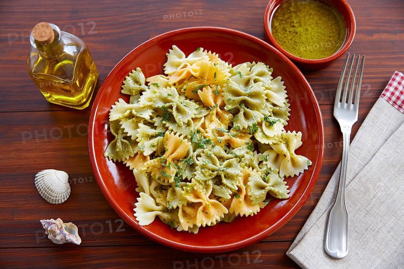 Farfalle pasta with Pesto on wooden table