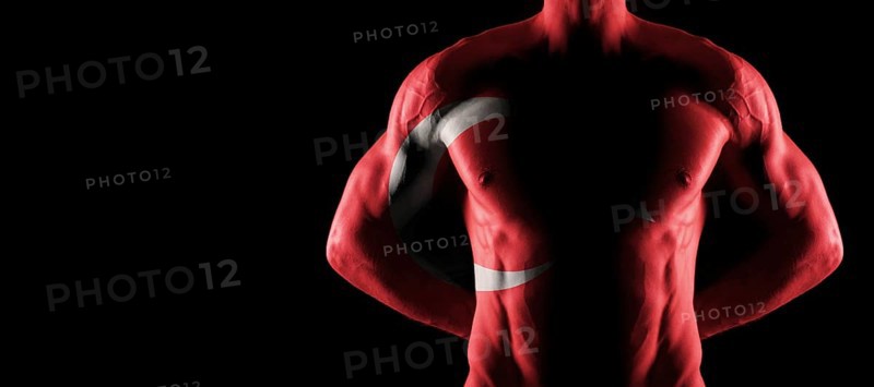 Turkey flag on muscled male torso with abs, black background