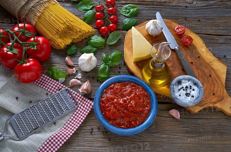 Italian Spaghetti pasta food with cheese tomato garlic basil on wood