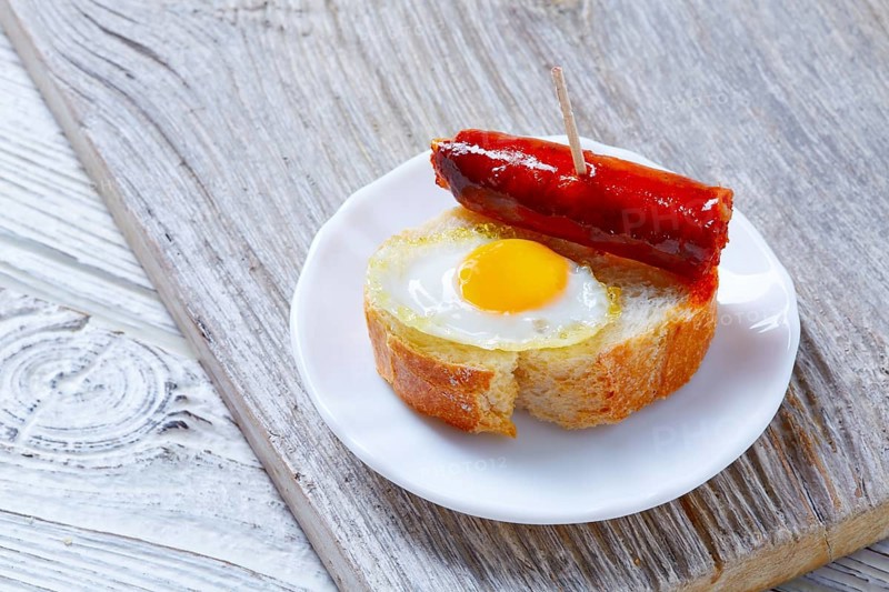 Pinchos pintxos chistorra with quail egg tapas from Spain sausage food