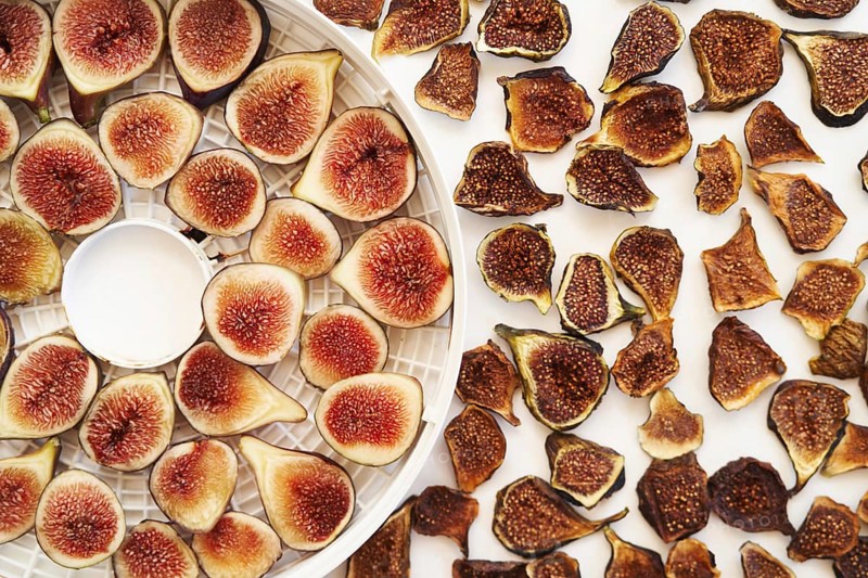 Sliced fresh and dried figs lie on the table. Top view.