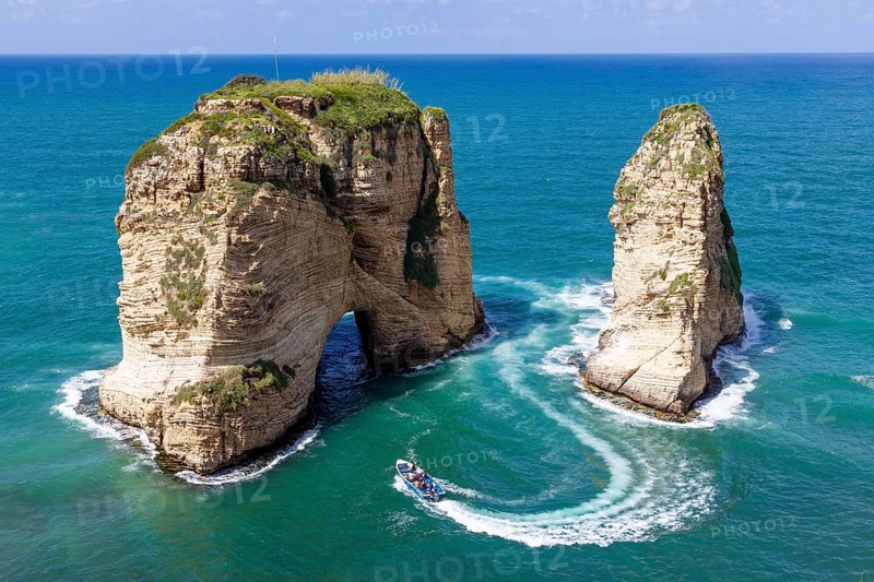 Rouche rocks in Beirut, Lebanon in the sea during daytime. Pigeon Rocks in Mediterranean sea