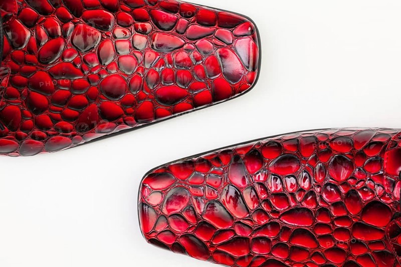Detail of men's red shoes on white background