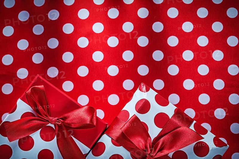 Decorated presents on polka-dot red table cloth holidays concept