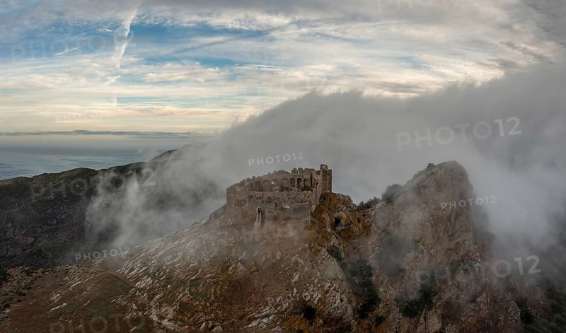 Magazzini, Italy, 14 November, 2023: drone view of the Castello del Volterraio shrouded in morning fog and cloud, Europe