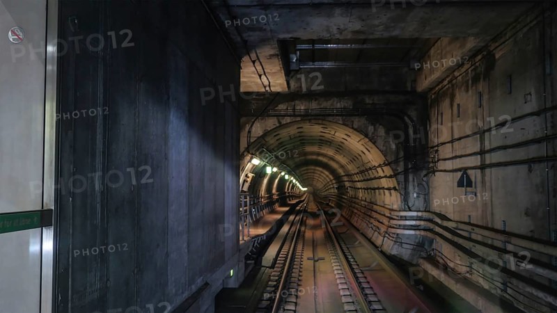 View on rails in metropolitan tube in lamps light