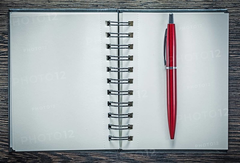 Spiral notepad ballpoint pen on vintage wooden board