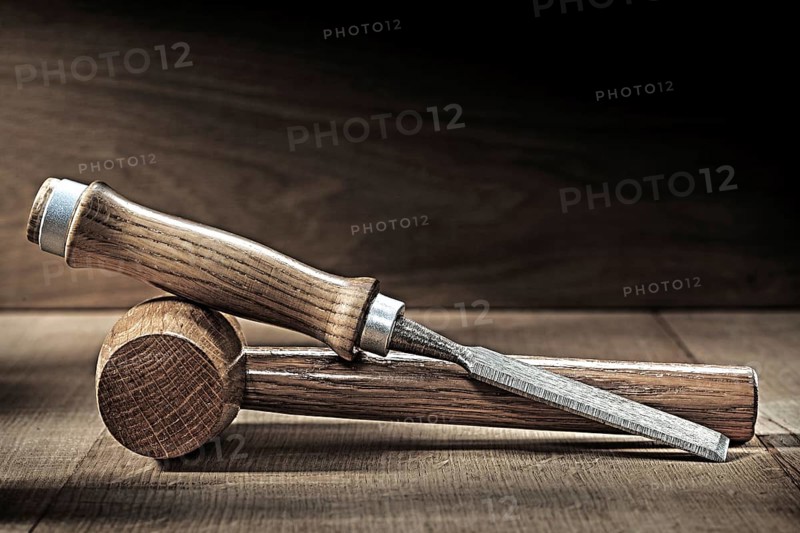 Chisel and small wooden malet on vintge wood