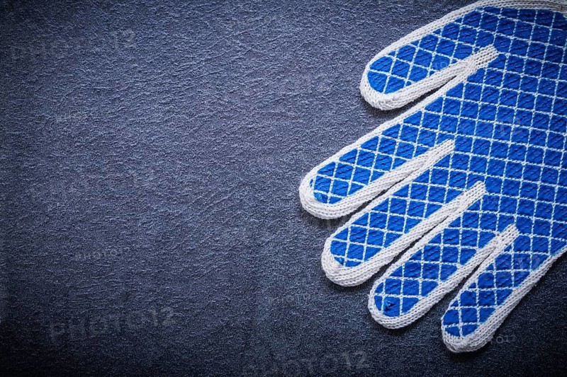 Protective gloves on black background copyspace construction concept