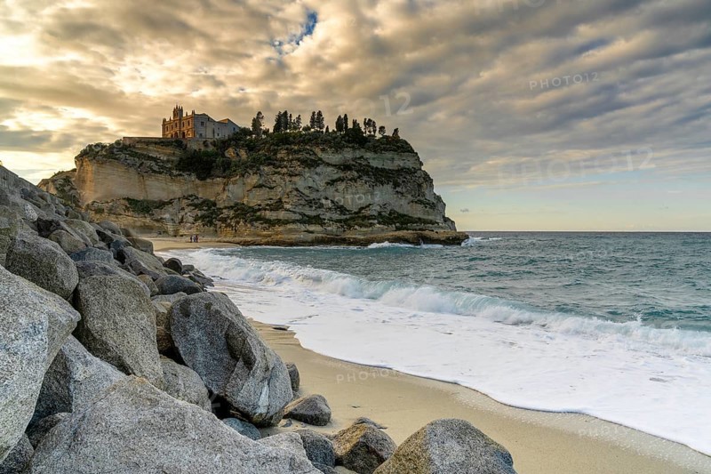 Tropea, Italy, 16 December, 2023: view of the Santa Maria dell'Isola Church on its rocky promontory in Tropea at sunset, Europe
