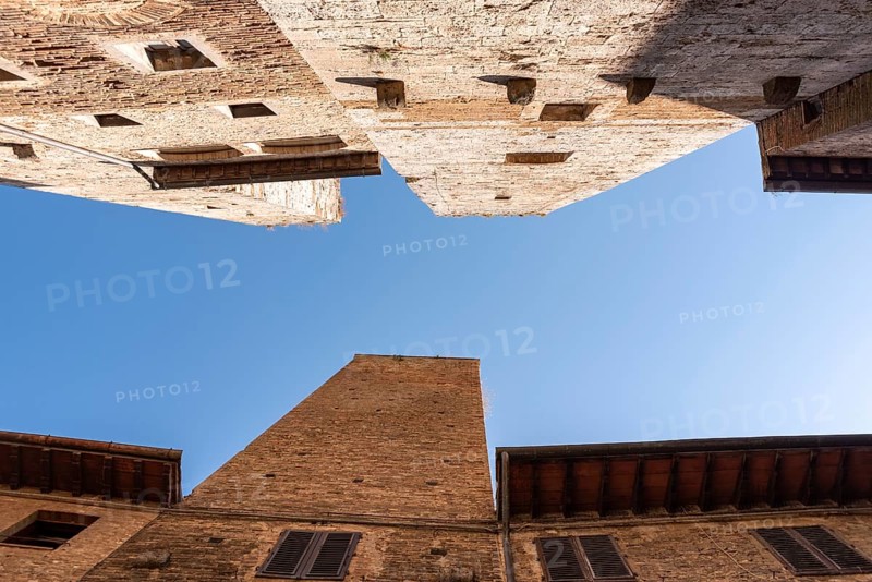 In the streets of San Gimignano, view on the towers Pettini and Salvucci, Italy, Europe