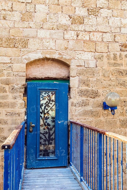 Doors bound by metal bars. Sunset. Old Yaffo - one of the most ancient cities of the world. Warm summer evening. Century masonry walls. Concept active, informative and photo of tourism