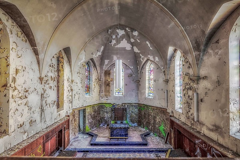 Church interior with colourfully decorated stained glass windows and an old altar, Agnus Dei, Lost Place, Plombières, Province of Liège, Belgium, Europe