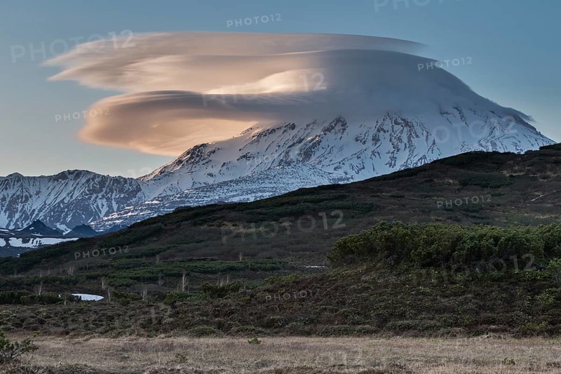 Beautiful clouds over the volcano at sunset. Active Ichinsky Volcano, Kamchatka Peninsula, Far East, Russia, Eurasia, Europe