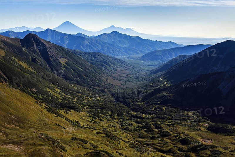 Beautiful autumn mountain landscape: scenery view of mountains, lake and volcanoes. Eurasia, Russian Far East, Kamchatka Peninsula