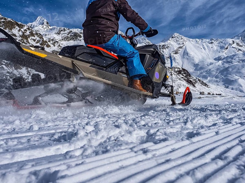 Snowmobile on a trail in the Italian alps