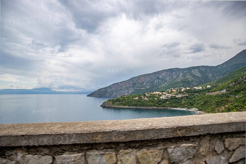Coastal landscape shot. View from a road leading along the sea and through a breathtaking green Mediterranean landscape. Coast near Salerno, Italy, Europe