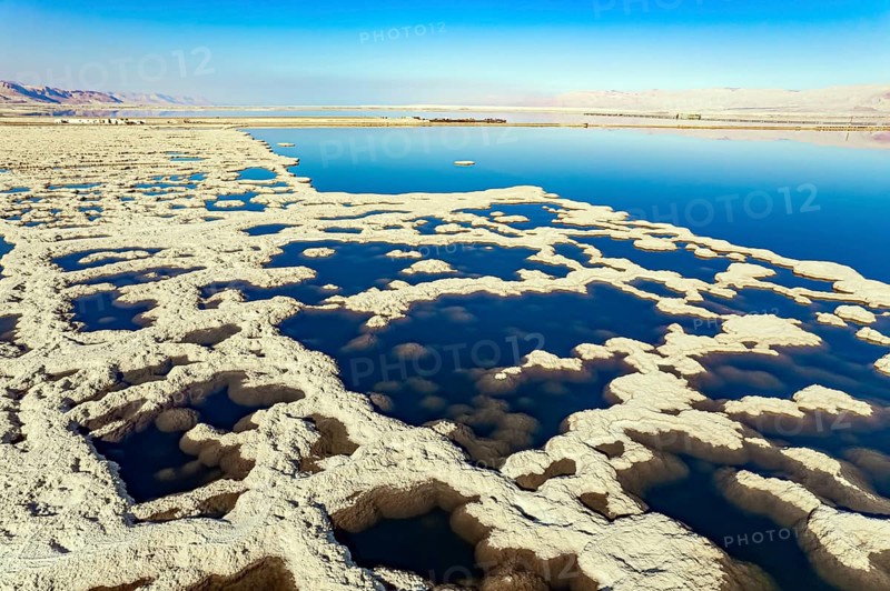 Israel. Dead Sea. The drainless salt lake in the Middle East, the saltiest lake in the world. On the surface of the water, the evaporated salt forms bizarre crystal shapes. The picture was taken by a drone from a aerial view