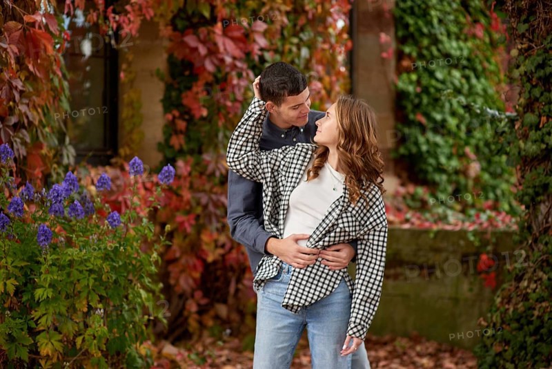 Young Cute Female Hugs Boyfriend. In Autumn Outdoor. Lovers Walking in Park. Attractive Funny Couple. Lovestory in Forest. Man and Woman. Cute Lovers in the Park. Family Concept. Happy Couple