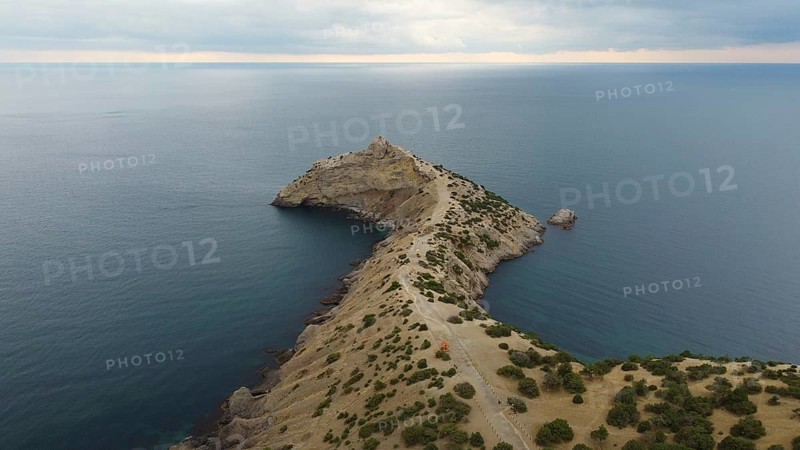 Autumn morning and a mountain landscape by the sea, a promontory protruding into the water