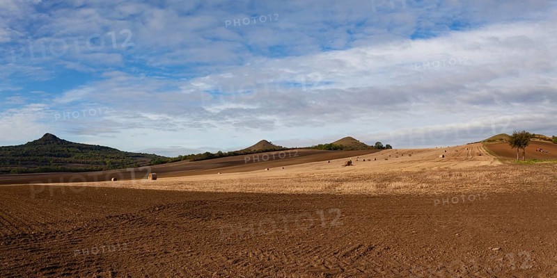 Straw bales on a stubble in Central Bohemian Uplands, Czech Republic. Field landscape bales of straw on a farm field