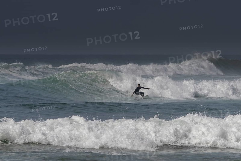 Sidi Ifni, Morocco, 17 March, 2024: man surfing a large wave off the coast of southern Morocco in Sidi Ifni, Africa