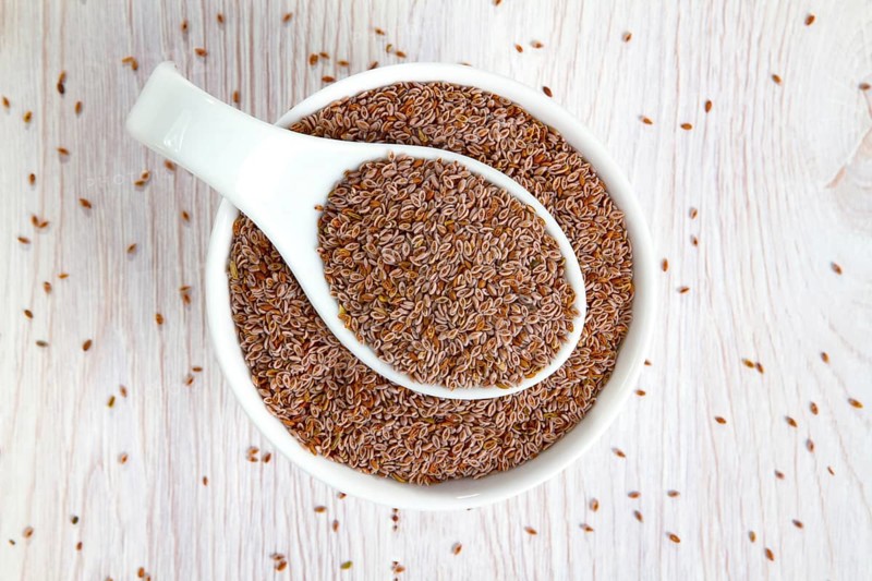 Top view of psyllium seeds in a white porcelain bowl