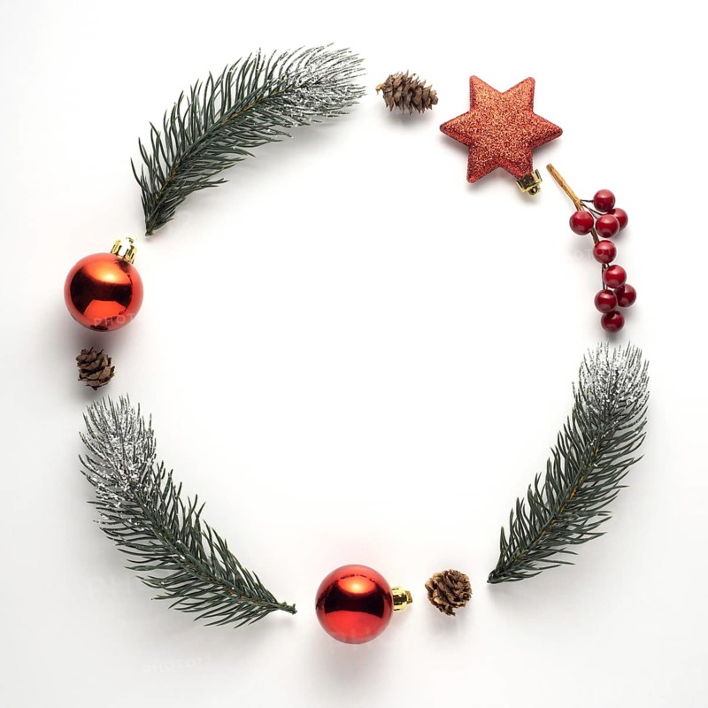 Creative concept still life holiday Christmas photo of fir branches and berries in the shape of wreath on white background