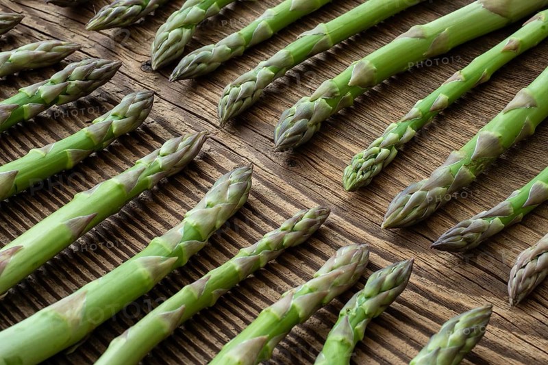 Fresh raw garden asparagus on rustic wooden table background