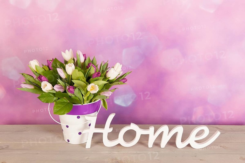 Colorful tulips in vase in interior