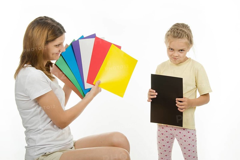 Girl shows girl pictures with flowers, and the girl said what color the pictures