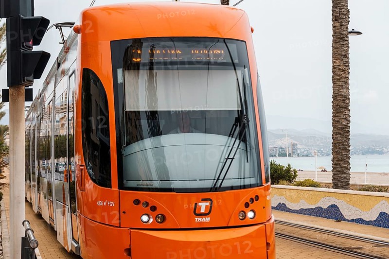 Alicante, Spain, October 14, 2023: Orange streetcar running along the promenade between Alicante and San Juan, Europe