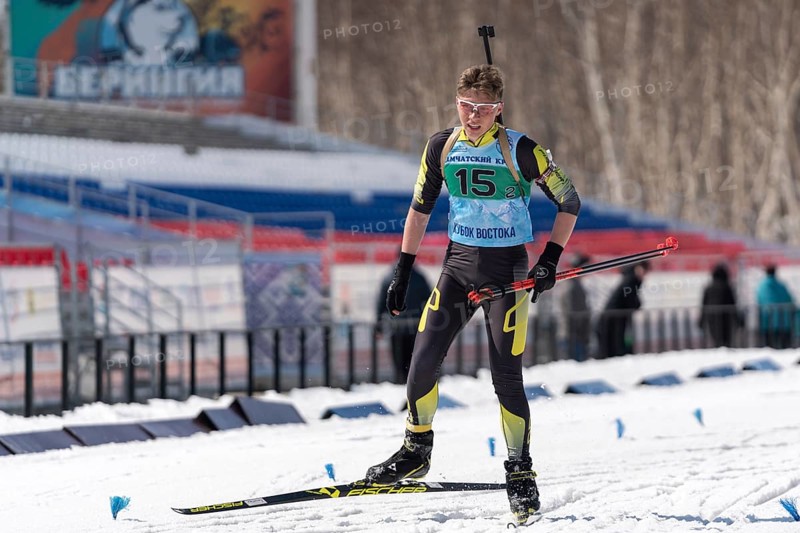 Sportsman biathlete Khanzutin Artem skiing on ski track distance biathlon stadium during Junior biathlon competitions East Cup. Petropavlovsk City, Kamchatka Peninsula, Russian Far East, Apr 14, 2019