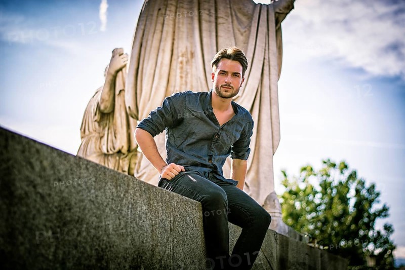 One handsome young man in urban setting in European city, Turin in Italy
