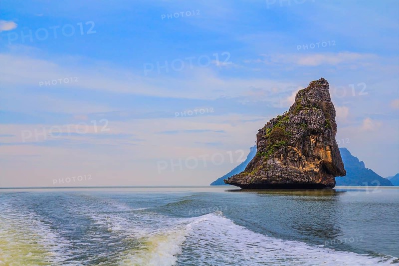 Fantastic beauty island-rock in the southern seas. The photo was taken from a fast sailing boat