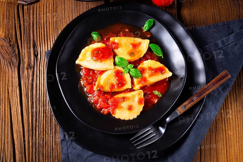Ravioli alla genovese with basil and tomato sauce