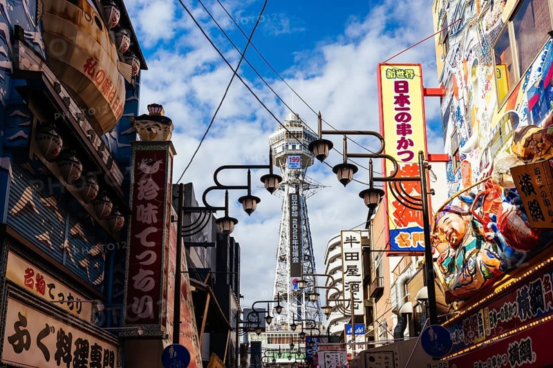 OSAKA, JAPAN - SEPTEMBER 26 2024: The famous Shinsekai area with Tsutenkaku Tower on a clear autumn day in Osaka, Japan, Asia