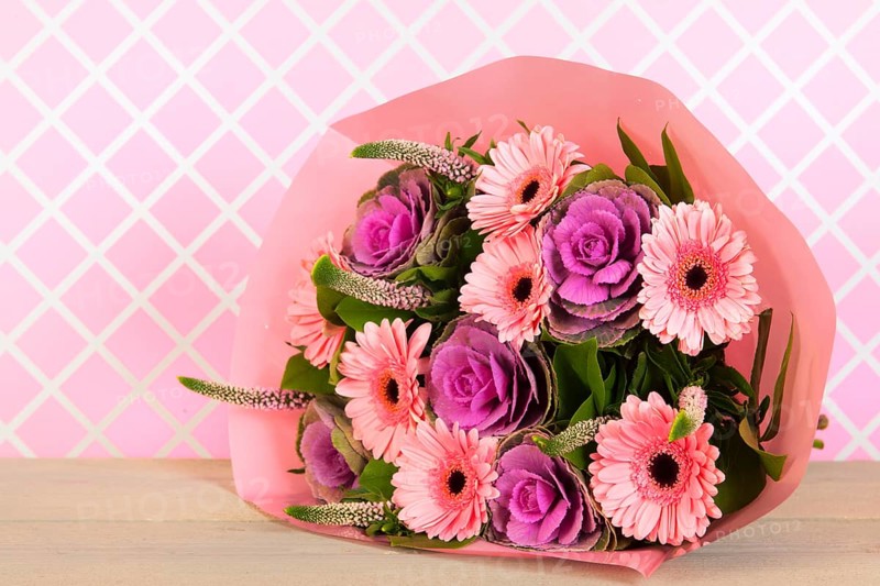 Colorful wrapped pink and purple bouquet in interior