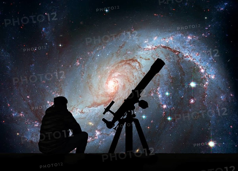 Man with telescope looking at the stars. Stellar Nursery NGC 1672. Spiral galaxy in the constellation Dorado Elements of this image are furnished by NASA