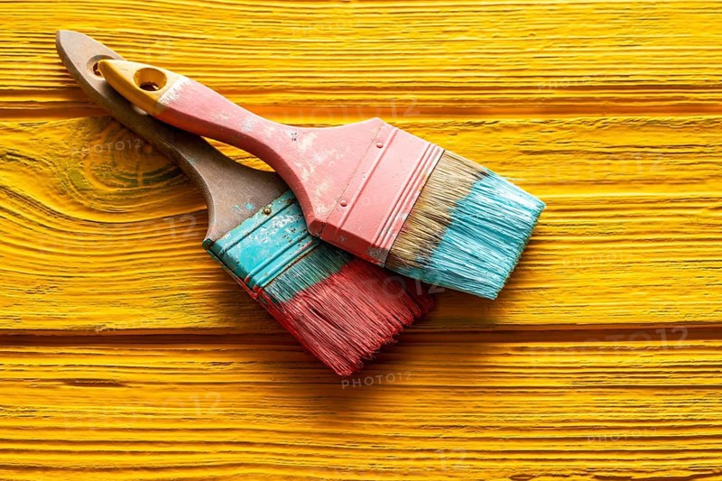 Coral color and yellow vivid grunge brushes on aged painted wood