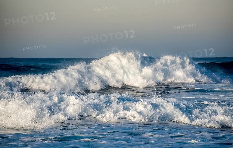 Dangerous wavy ocean with wind waves crashing during tropical storm