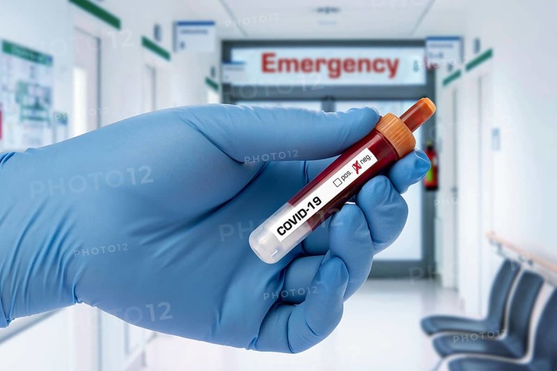 Covid 19 person holding a test tube with coronavirus, in the lab