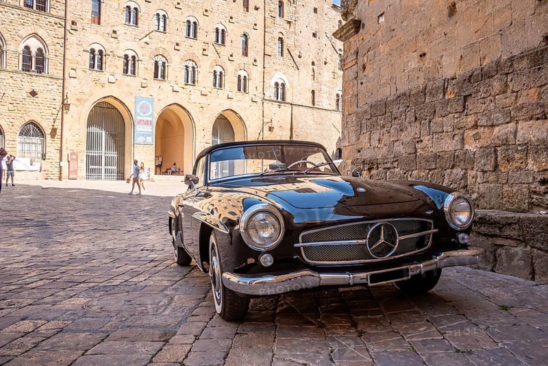 VOLTERRA, ITALY, OCTOBER 15, 2023, A Mercedes Benz 190SL vintage car in the town center of Volterra in the Tuscany