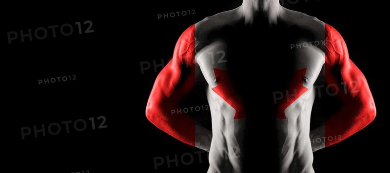 Canada flag on muscled male torso with abs, black background