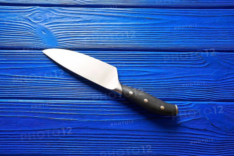 Chef tools black knife on a blue wooden background