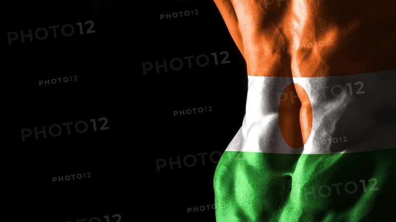 Niger flag on abs muscles national sport workout, bodybuilding concept, black background