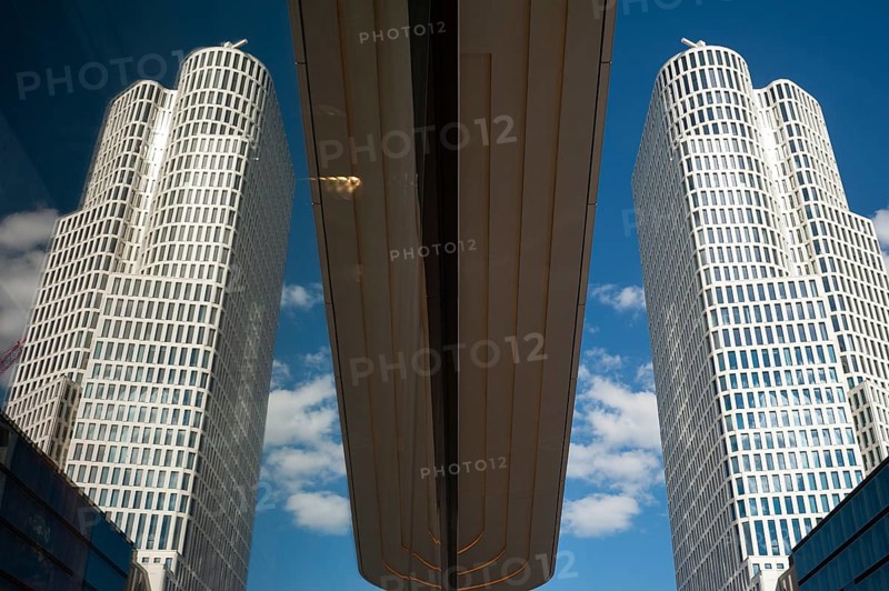 08.06.2019, Berlin, Germany, Europe, The tower of the Upper West building complex on Kurfürstendamm in Berlin-Charlottenburg is reflected in a shop window. The building was designed by architects Christoph Langhof and KSP Jürgen Engel, Europe