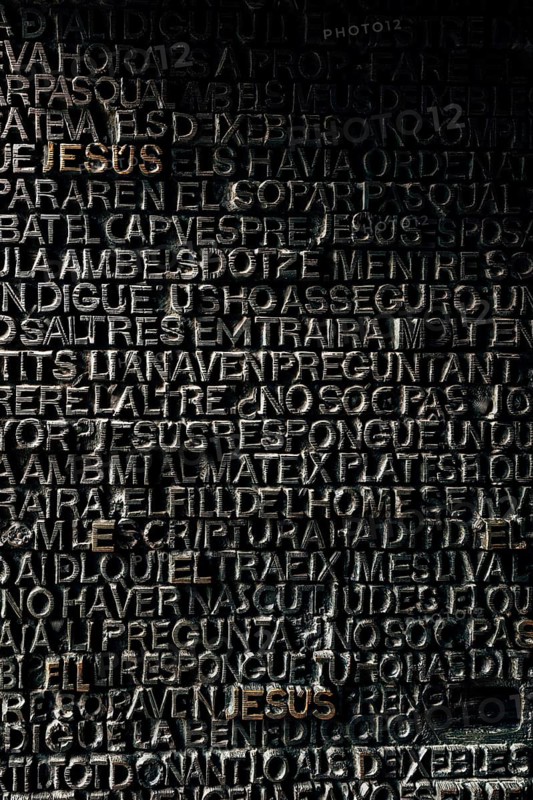 Detail with word Jesus on the bronze door of Passion facade of Sagrada Familia in Barcelona. The gospel doors contain text from the New Testament depicting the Passion of Christ.