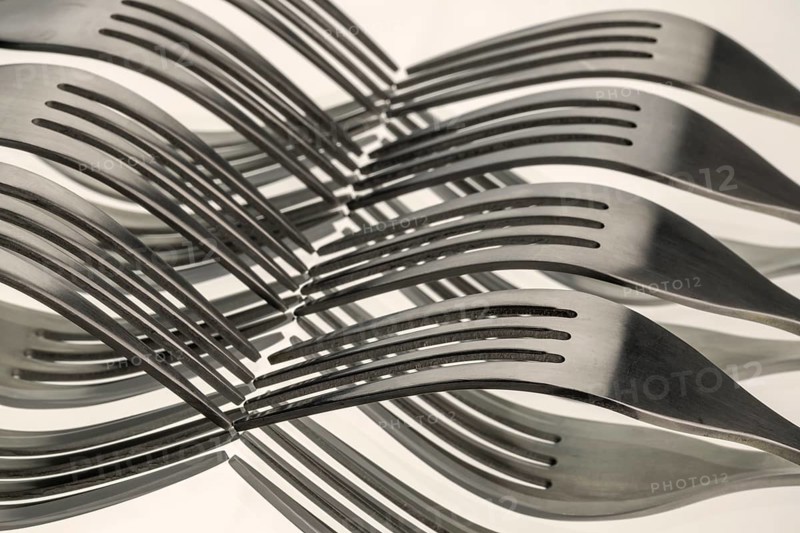 Abstract artistic picture of wavy forks, which form a wave pattern by means of mirroring