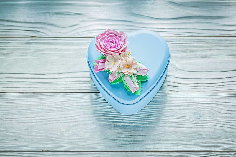 Heart-shaped present box on wooden board holidays concept